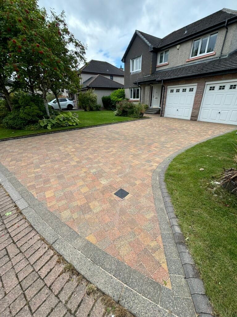 the after photo of a colourful driveway after we pressure washed it and resanded it